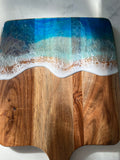 Acacia wood paddle board wth triple blue ocean waves
