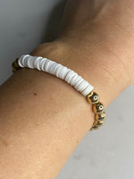 White heishi beads with gold plated hematite beads