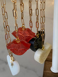 Lip resin necklace on gold plated chain.