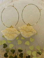Sparkly resin lip 👄 earrings dangling from 14k gold plated hoops or danglers.