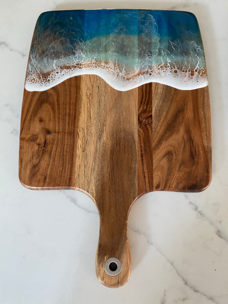 Acacia wood paddle board wth triple blue ocean waves