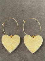 Gold resin heart matte dangly earrings. (One pair)