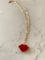 Lip resin necklace on gold plated chain.